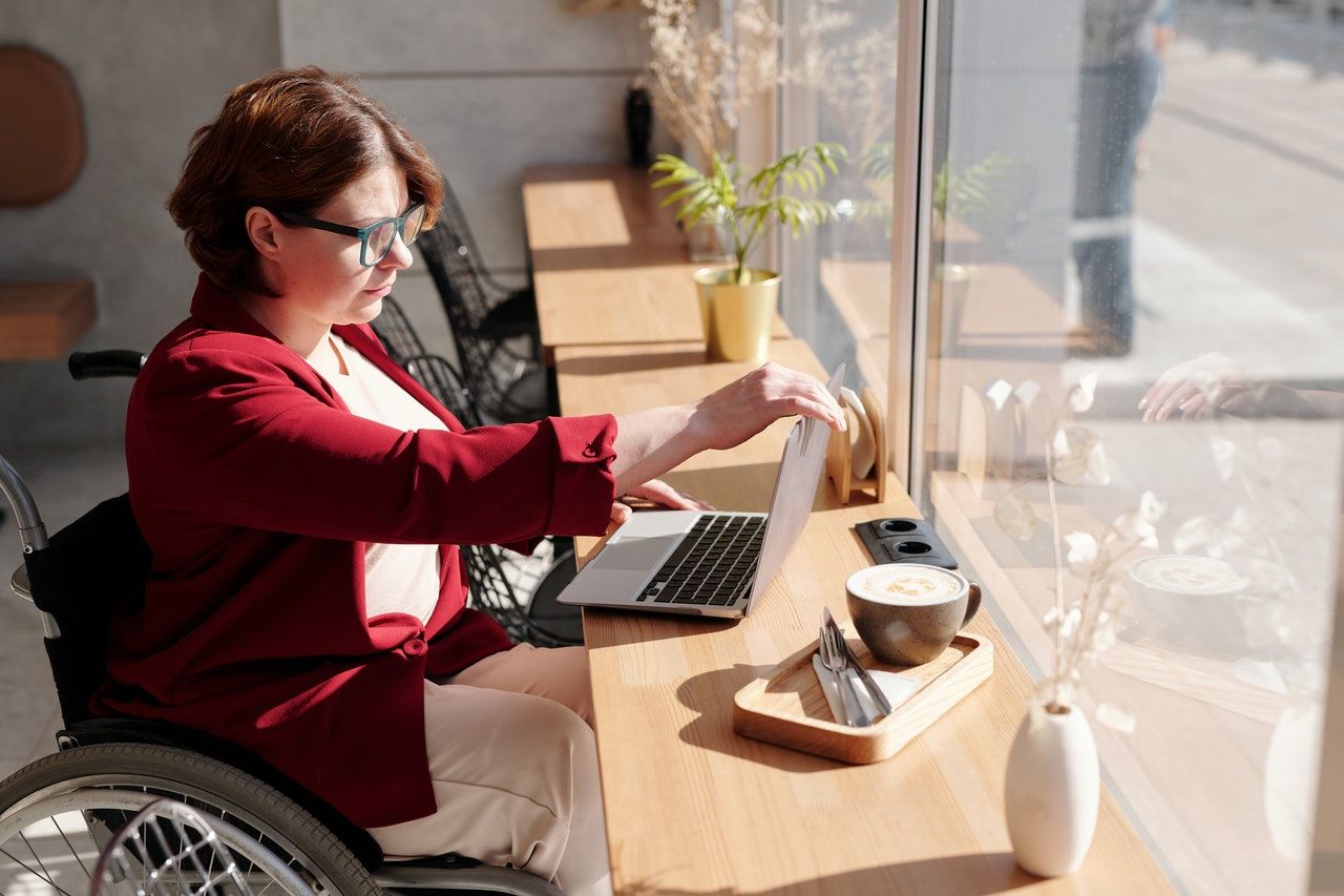 woman in a wheelchair using a laptop