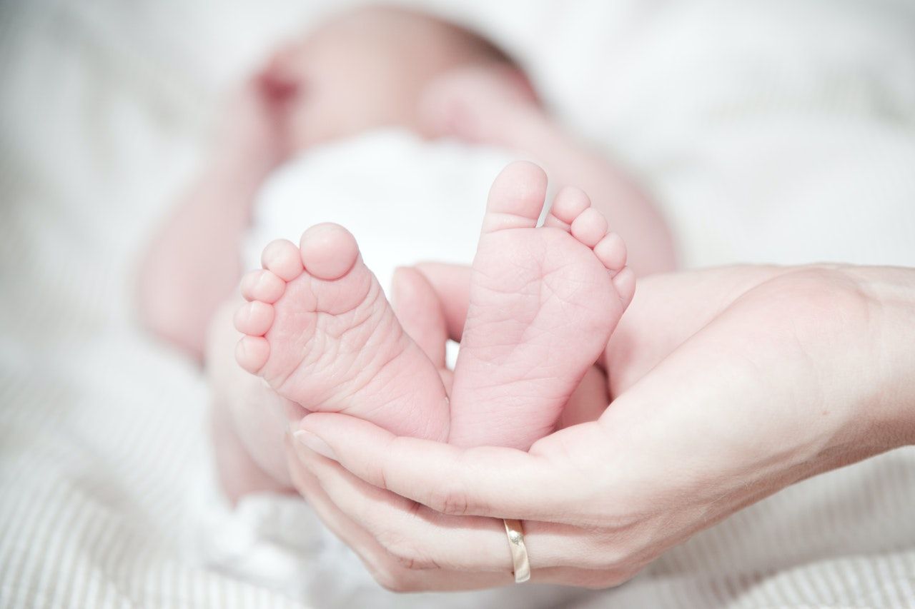 woman holding a babies feet